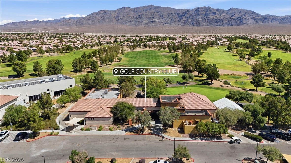7940 Fantail Drive, North Las Vegas, NV 89084 Sweeping mountain ridges frame a manicured fairway adjacent to the tile-roofed country club clubhouse.
