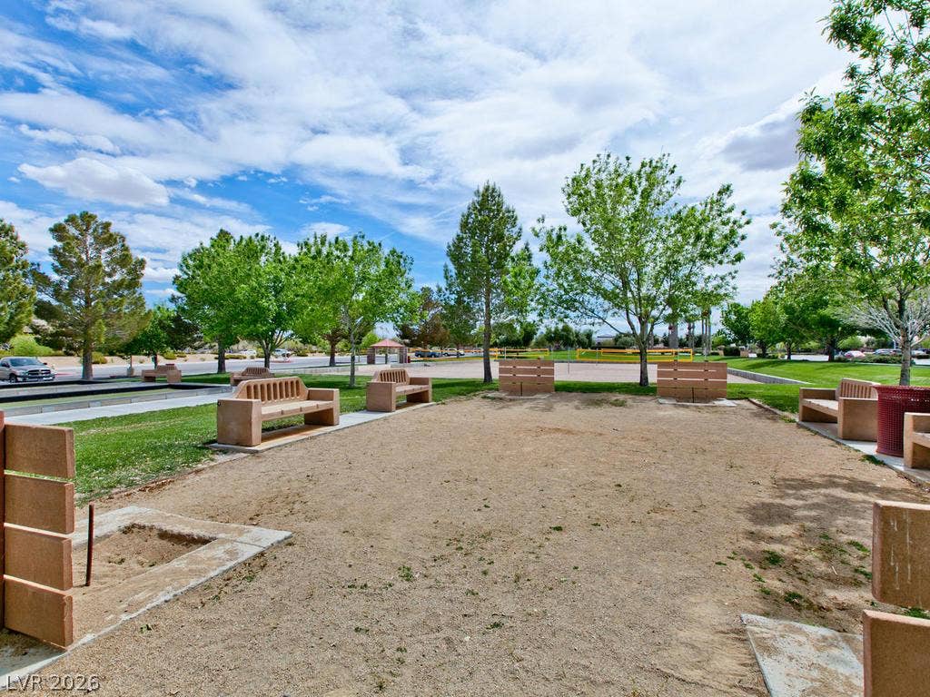 7940 Fantail Drive, North Las Vegas, NV 89084 A spacious outdoor recreation park features dedicated court spaces bordered by mature green trees.