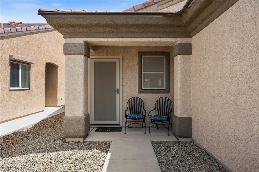 7940 Fantail Drive, North Las Vegas, NV 89084 An inviting covered entryway leads directly to the front door of this stucco home.