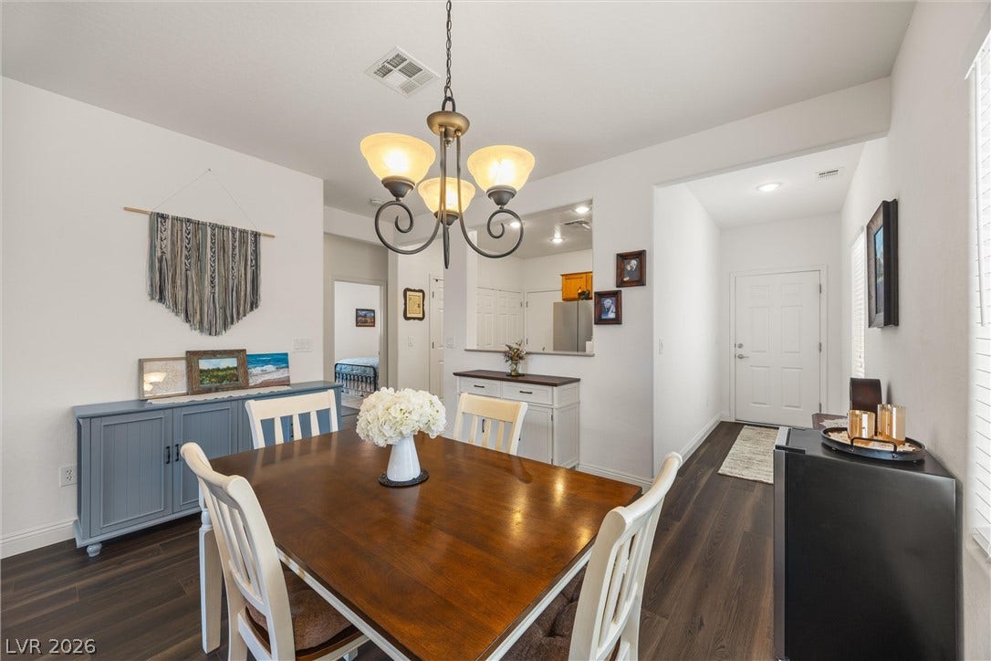7940 Fantail Drive, North Las Vegas, NV 89084 Rich wood-look flooring anchors a welcoming dining area adjoining the main entryway hallway.