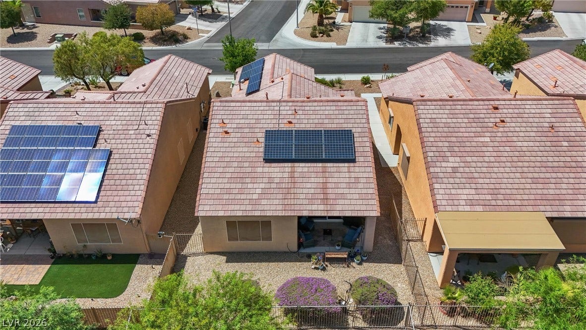 7940 Fantail Drive, North Las Vegas, NV 89084 An aerial perspective showcases a tile roof with installed solar panels and a private back patio.