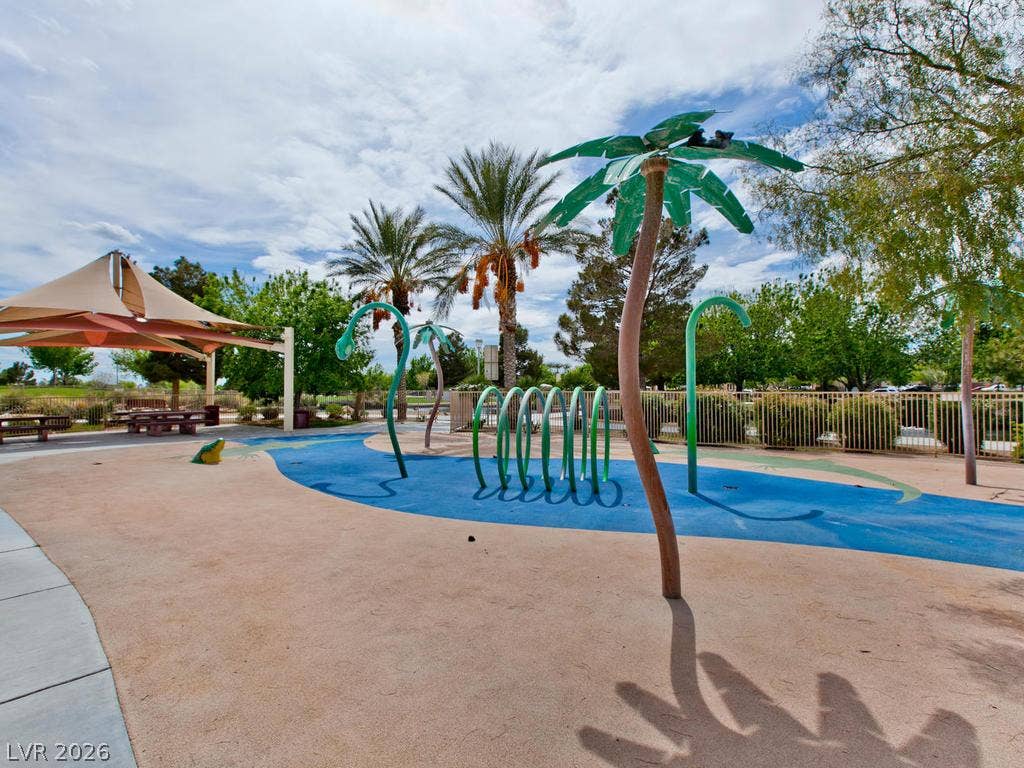 7940 Fantail Drive, North Las Vegas, NV 89084 An outdoor splash pad area features water play elements, safety surfacing, and palm tree accents.