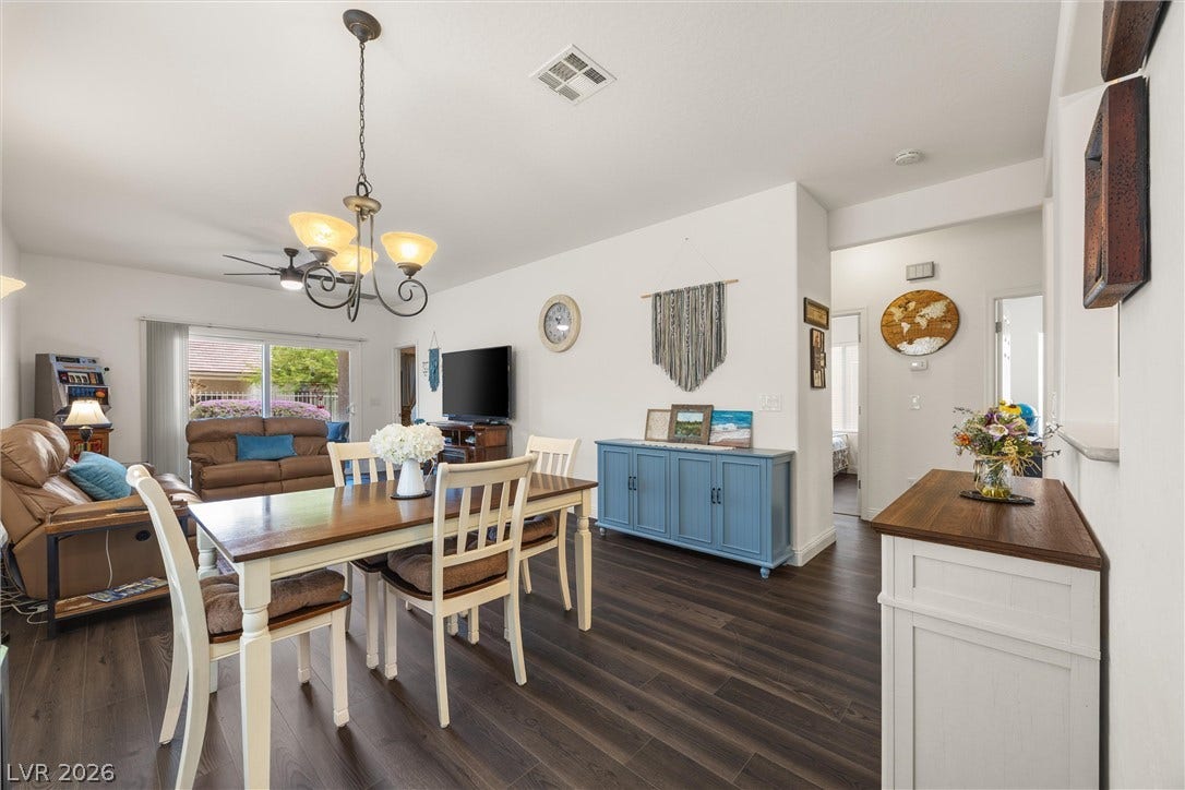 7940 Fantail Drive, North Las Vegas, NV 89084 Rich wood plank flooring sets a warm tone throughout this open-concept dining area.
