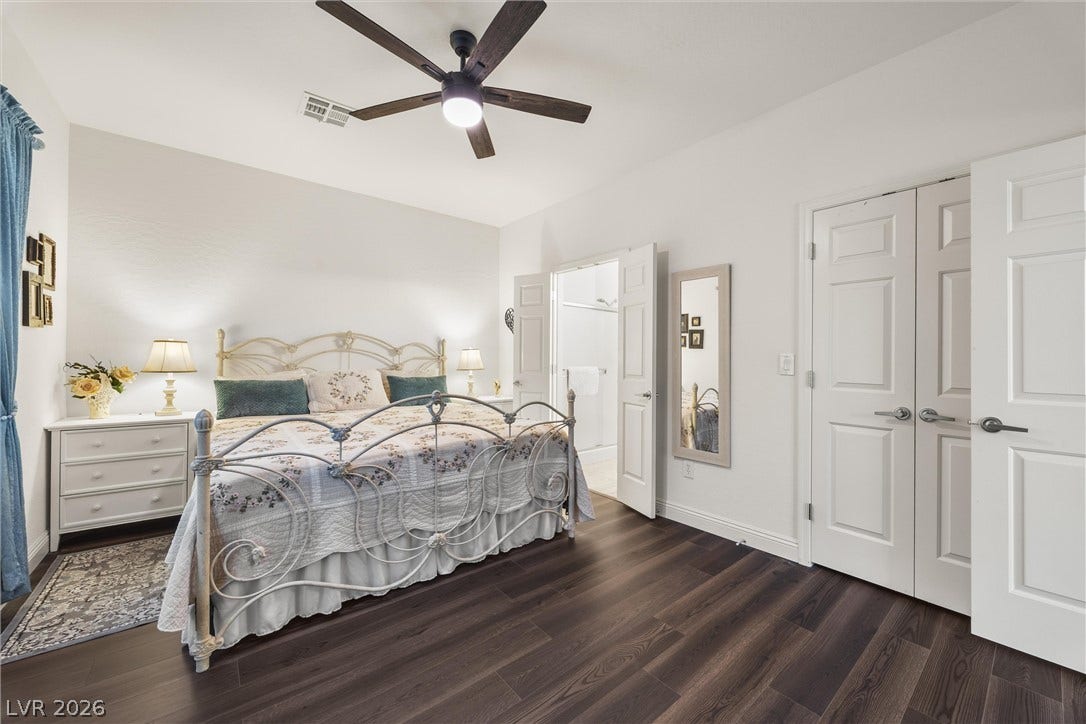 7940 Fantail Drive, North Las Vegas, NV 89084 Rich wood-plank flooring contrasts beautifully with smooth walls in this comfortable sleeping space.