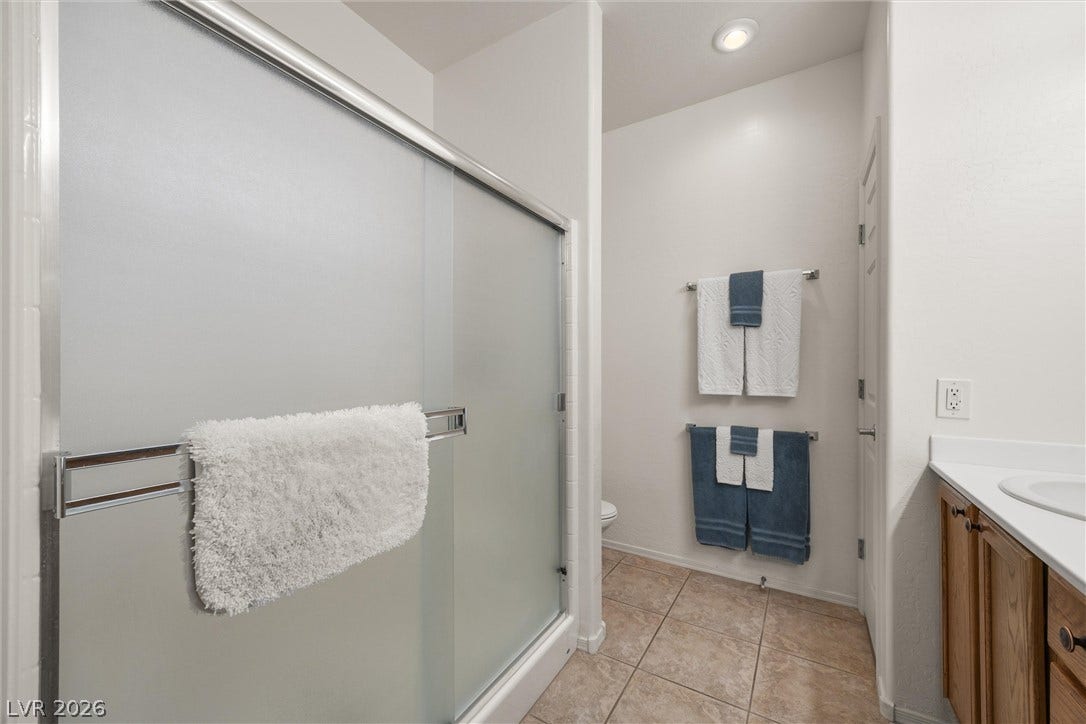 7940 Fantail Drive, North Las Vegas, NV 89084 Functional layout features a walk-in shower and stone-look tile flooring.