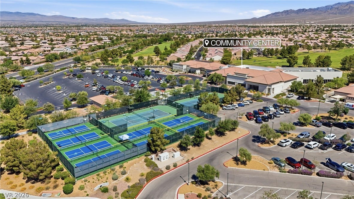 7940 Fantail Drive, North Las Vegas, NV 89084 An aerial perspective showcases the extensive community center, parking facilities, and surrounding neighborhood.