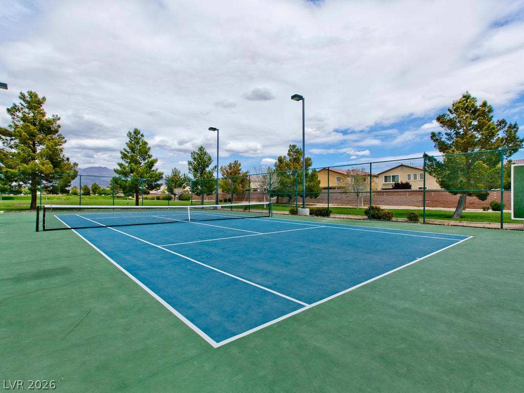 7940 Fantail Drive, North Las Vegas, NV 89084 An outdoor tennis court features professional lighting and a secure perimeter fence.