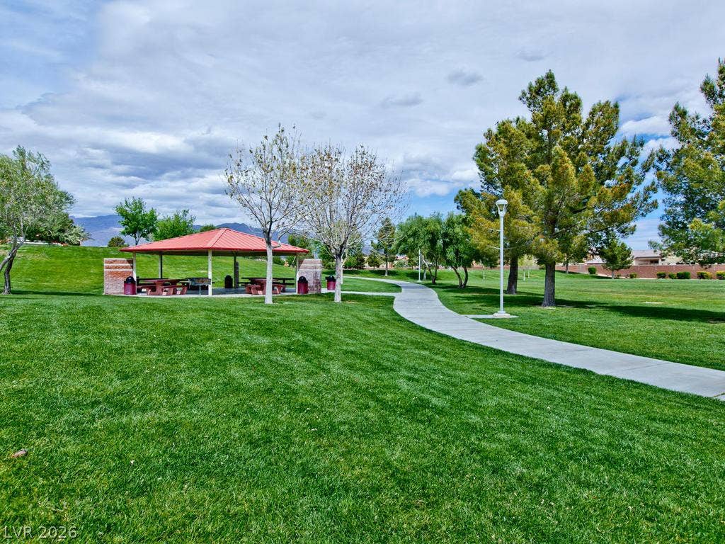 7940 Fantail Drive, North Las Vegas, NV 89084 A paved walking path winds through manicured lawns near a covered picnic pavilion.