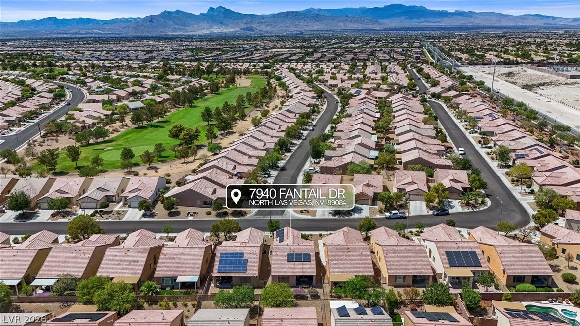 7940 Fantail Drive, North Las Vegas, NV 89084 Aerial view showcases the structured neighborhood layout and mountain backdrop.