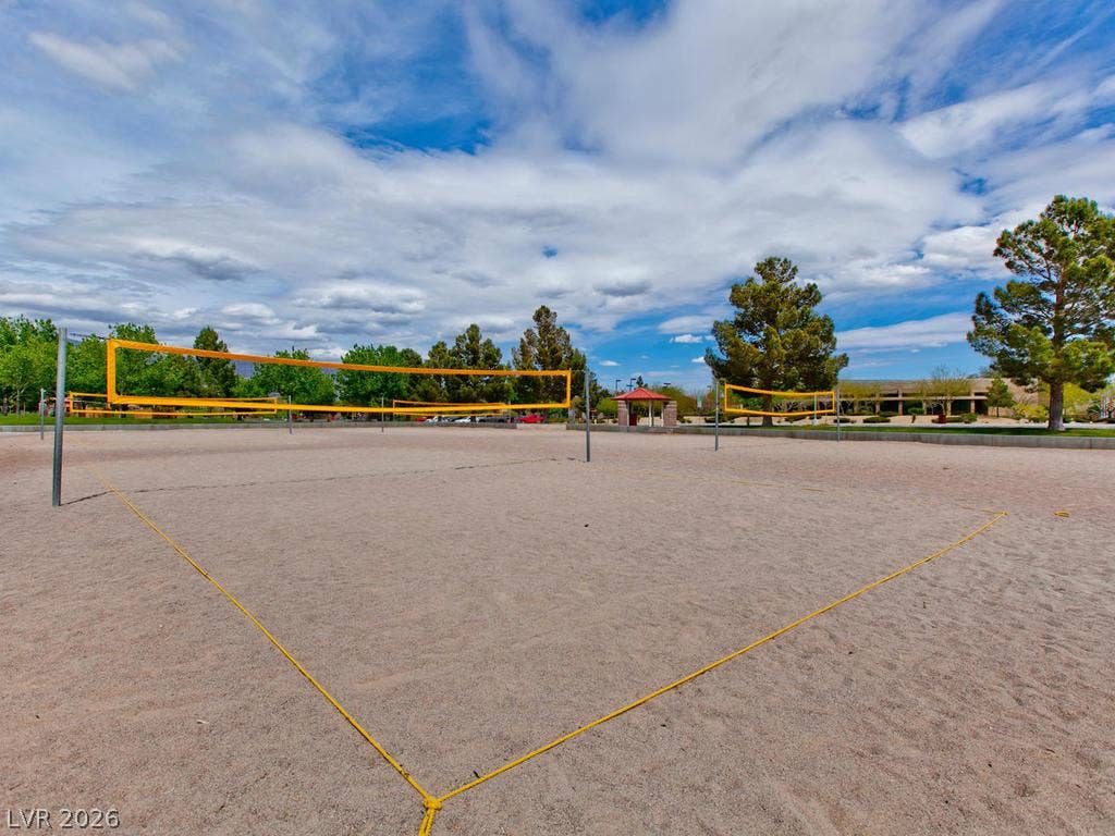 7940 Fantail Drive, North Las Vegas, NV 89084 Sandy volleyball courts sit beneath a wide blue sky bordered by mature trees.