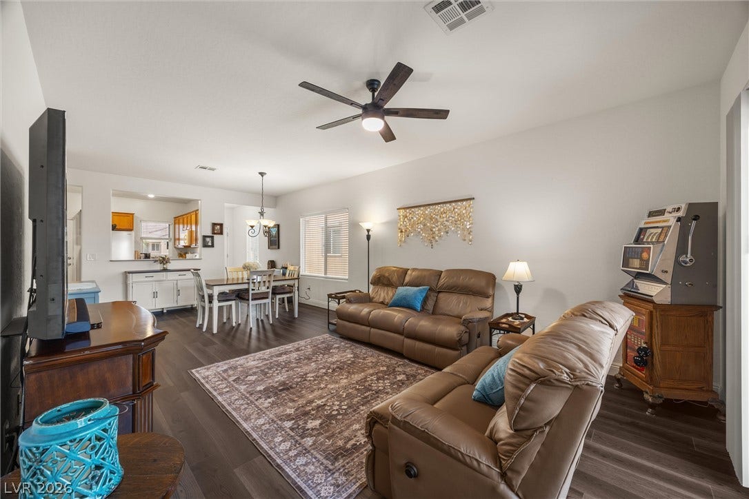 7940 Fantail Drive, North Las Vegas, NV 89084 Rich wood-look flooring anchors this inviting open-concept living area and adjacent dining space.