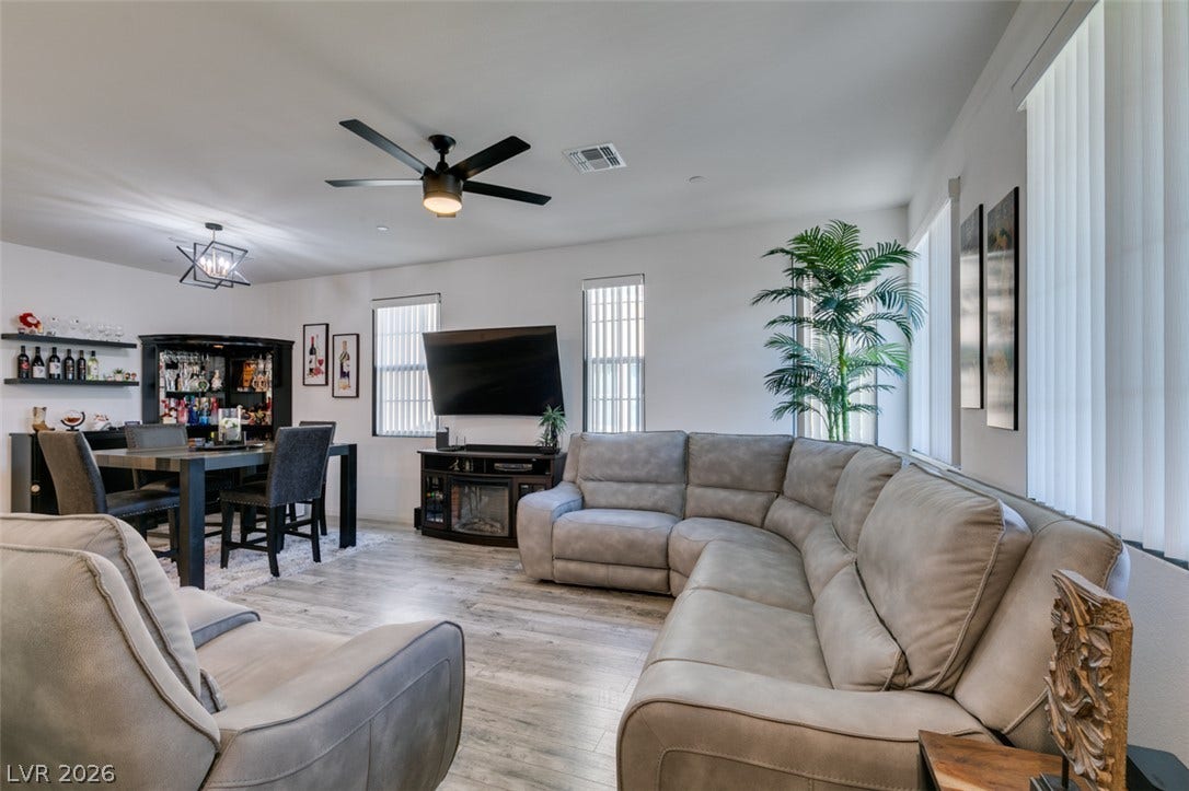 3231 Pergusa Drive, Henderson, NV 89044 An open living space highlights durable wood-look flooring and tall windows inviting plenty of natural light.