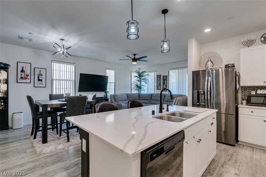 3231 Pergusa Drive, Henderson, NV 89044 Polished stone counters and durable wood-look flooring enhance this open-concept culinary space.