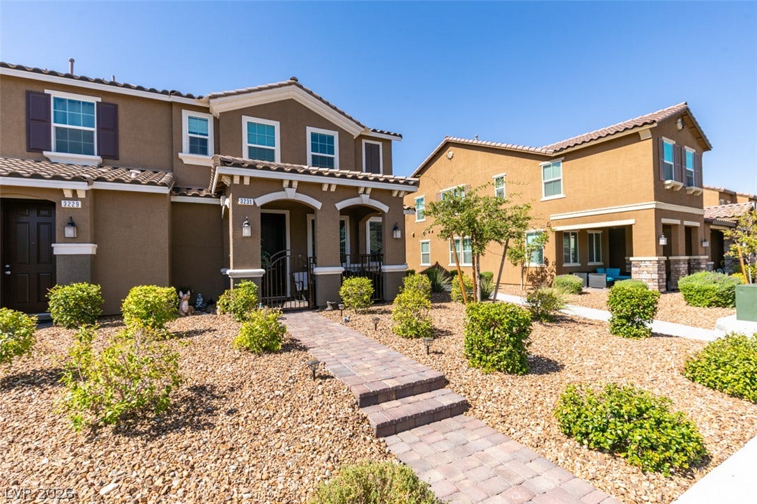 3231 Pergusa Drive, Henderson, NV 89044 A paved stone pathway leads directly to the covered entryway of this modern two-story townhouse.