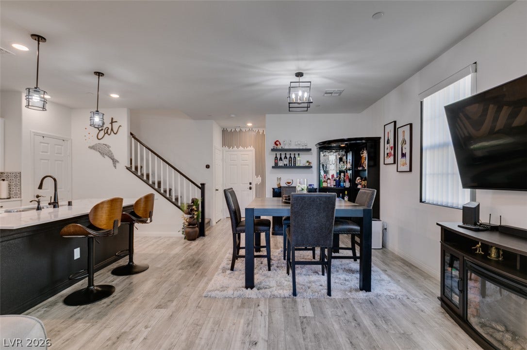 3231 Pergusa Drive, Henderson, NV 89044 Smooth wood-look flooring connects a central dining space and adjoining kitchen breakfast bar.