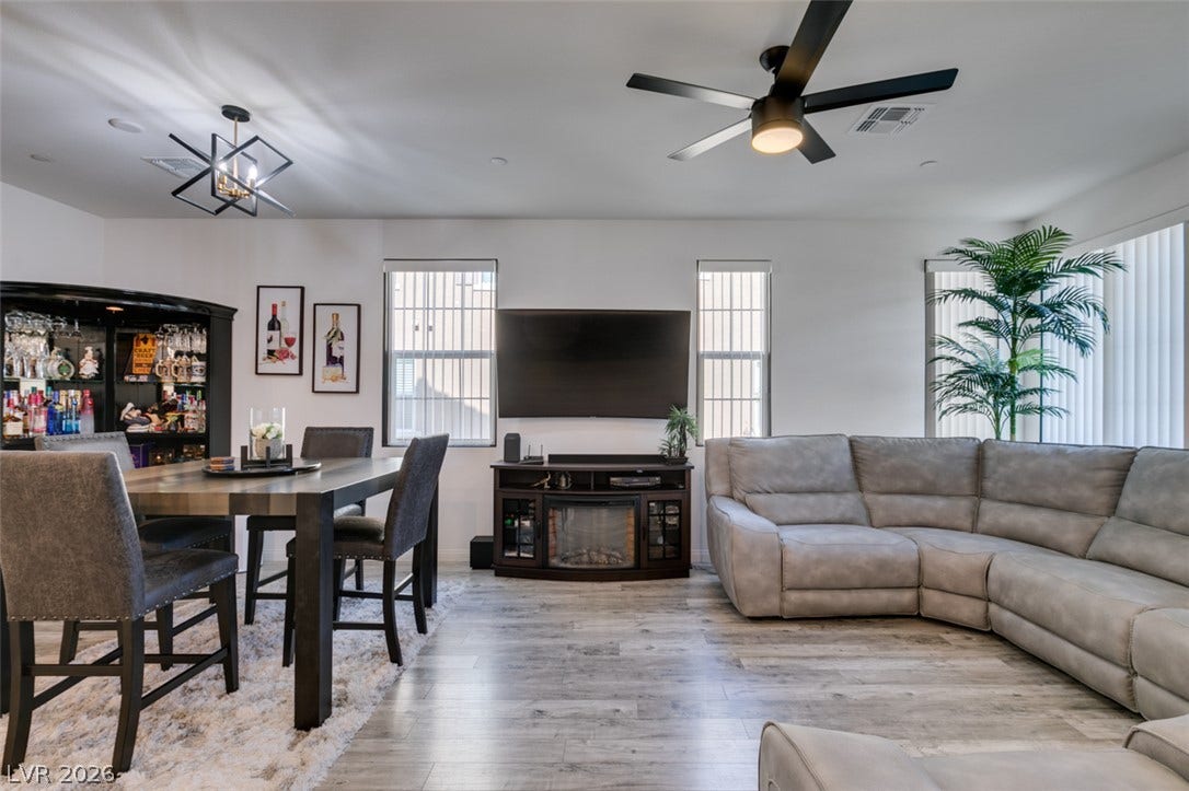 3231 Pergusa Drive, Henderson, NV 89044 An open layout connects the dining space and living area over smooth wood-style flooring.