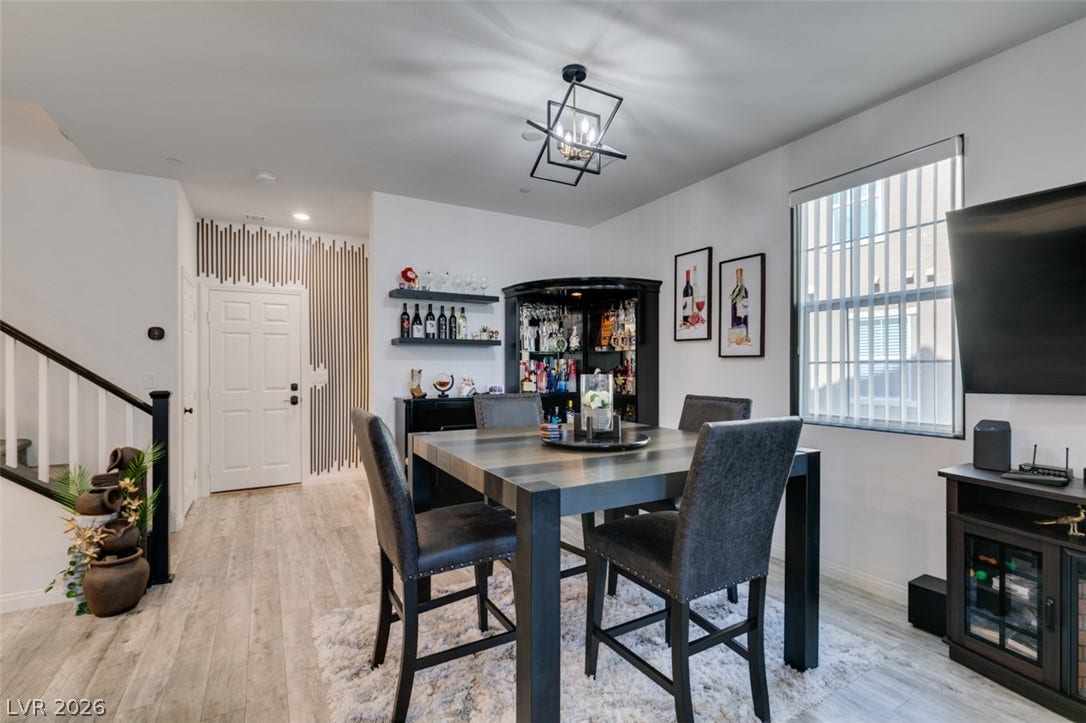 3231 Pergusa Drive, Henderson, NV 89044 Smooth wood-look flooring and tall windows define this open dining space.