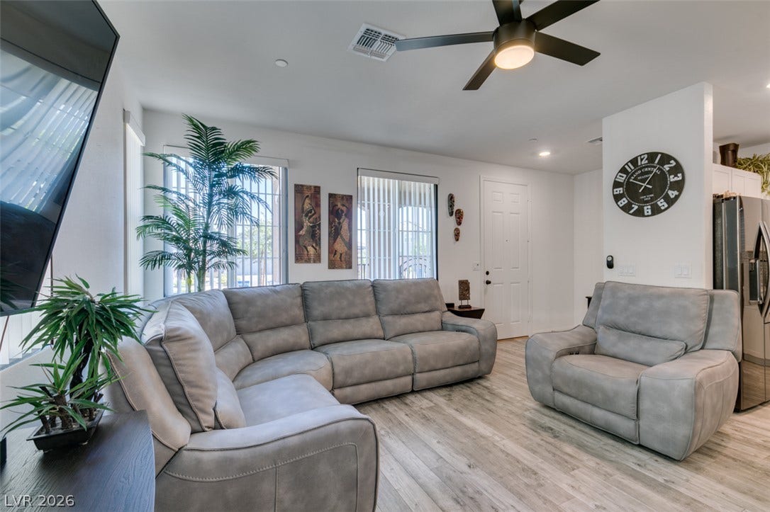 3231 Pergusa Drive, Henderson, NV 89044 Smooth wood-look flooring and tall windows create an airy atmosphere throughout the living space.
