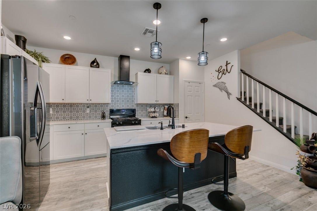 3231 Pergusa Drive, Henderson, NV 89044 Elegant quartz countertops and custom patterned tile backsplashes define this stylish culinary space.