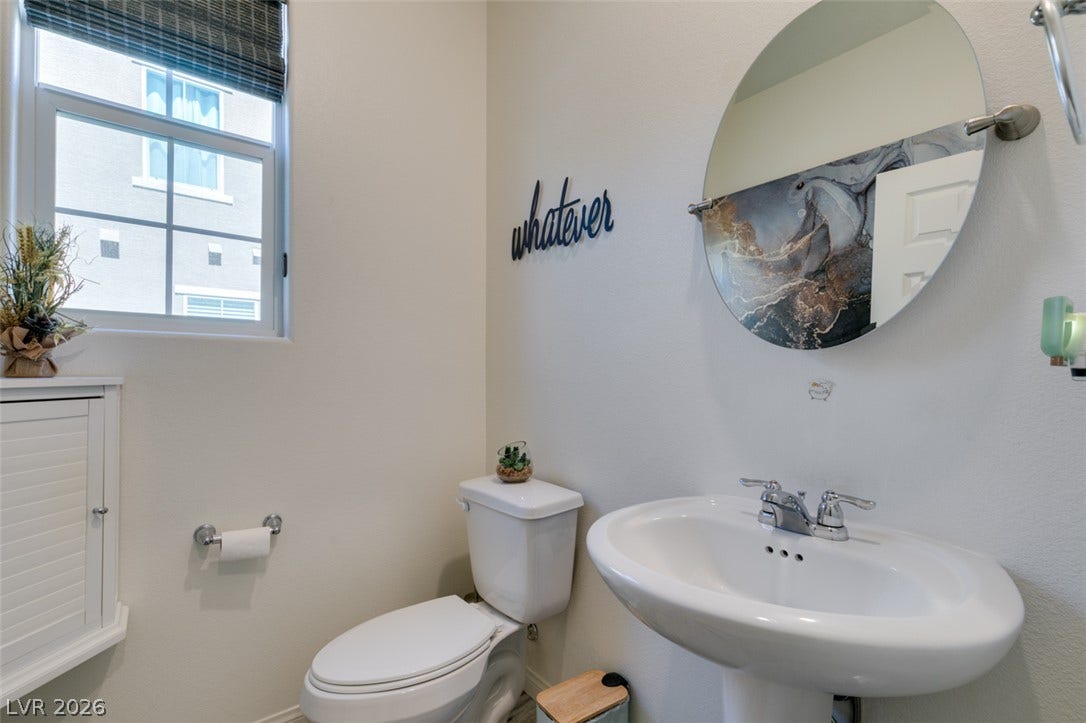 3231 Pergusa Drive, Henderson, NV 89044 A classic pedestal sink paired with neutral walls completes this functional half bath layout.