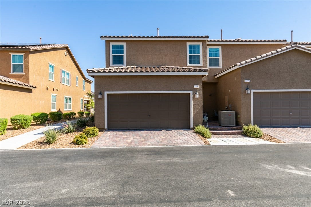 3231 Pergusa Drive, Henderson, NV 89044 Clay tile rooflines and stucco siding define this multi-level exterior architecture.