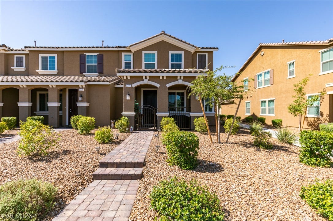 3231 Pergusa Drive, Henderson, NV 89044 A paved stone pathway leads directly to the front entrance of this modern multi-level townhouse.