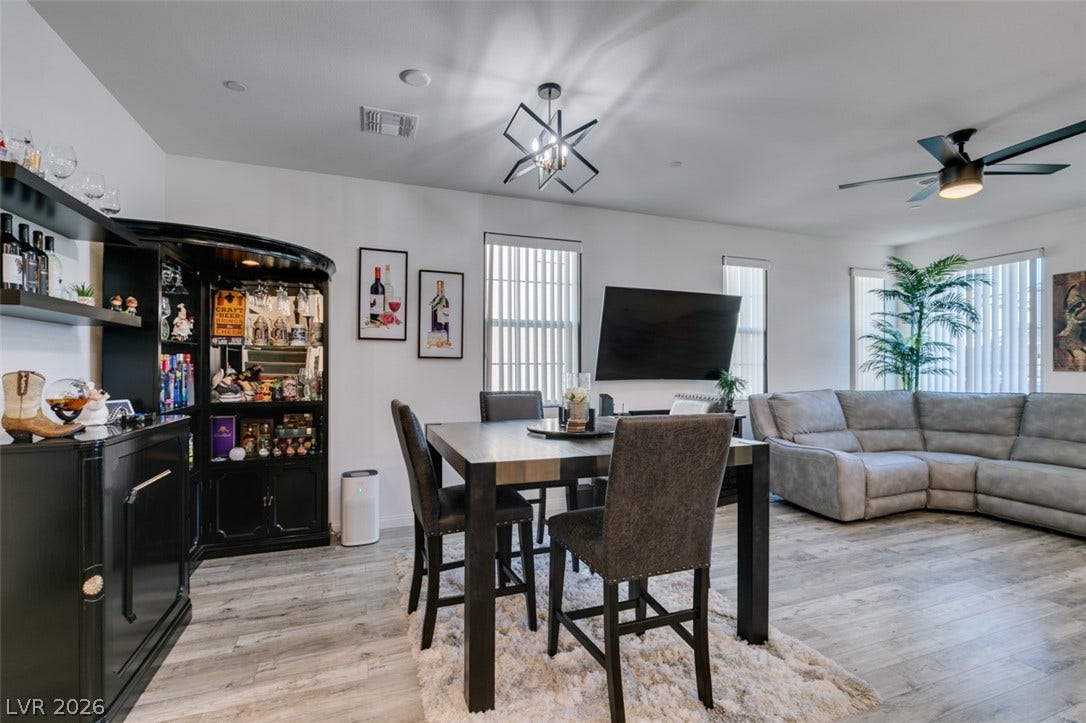 3231 Pergusa Drive, Henderson, NV 89044 An open layout connects the dining space and living area over modern wood-look flooring.