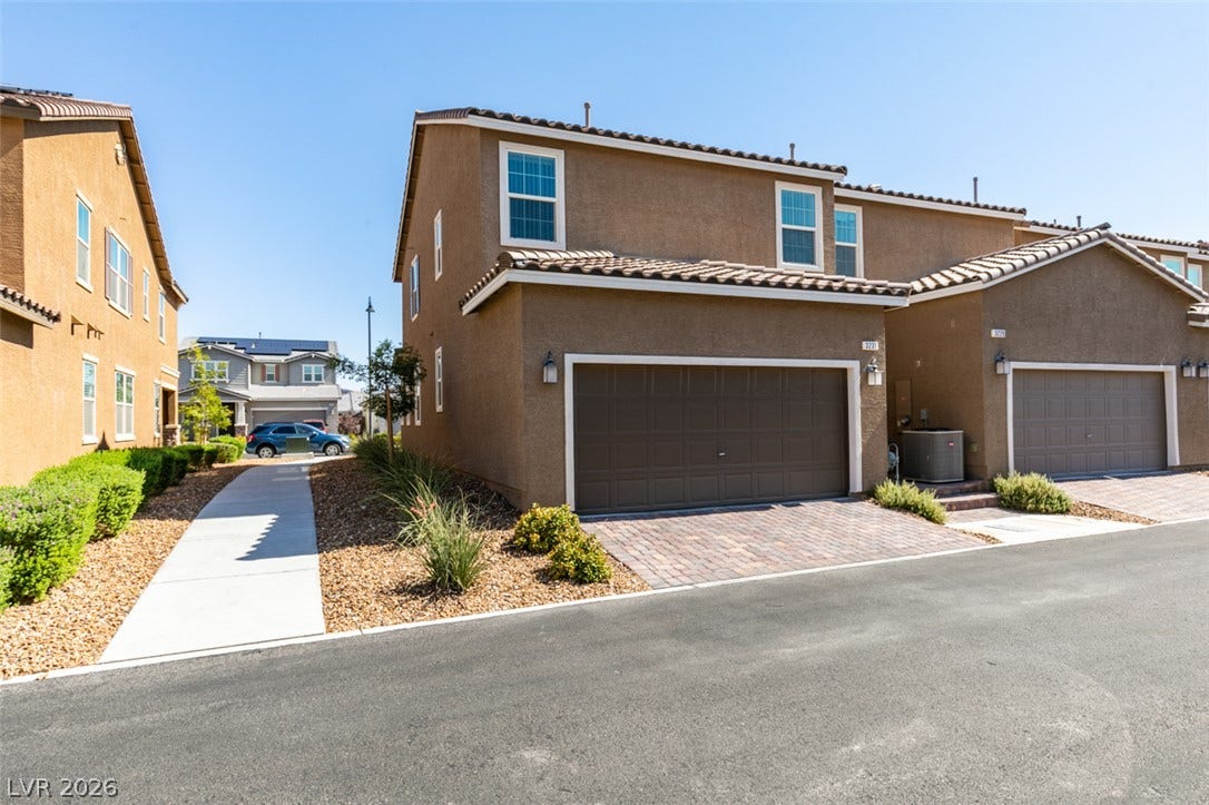 3231 Pergusa Drive, Henderson, NV 89044 Stucco exteriors paired with tile roofing define these multi-level townhome structures.
