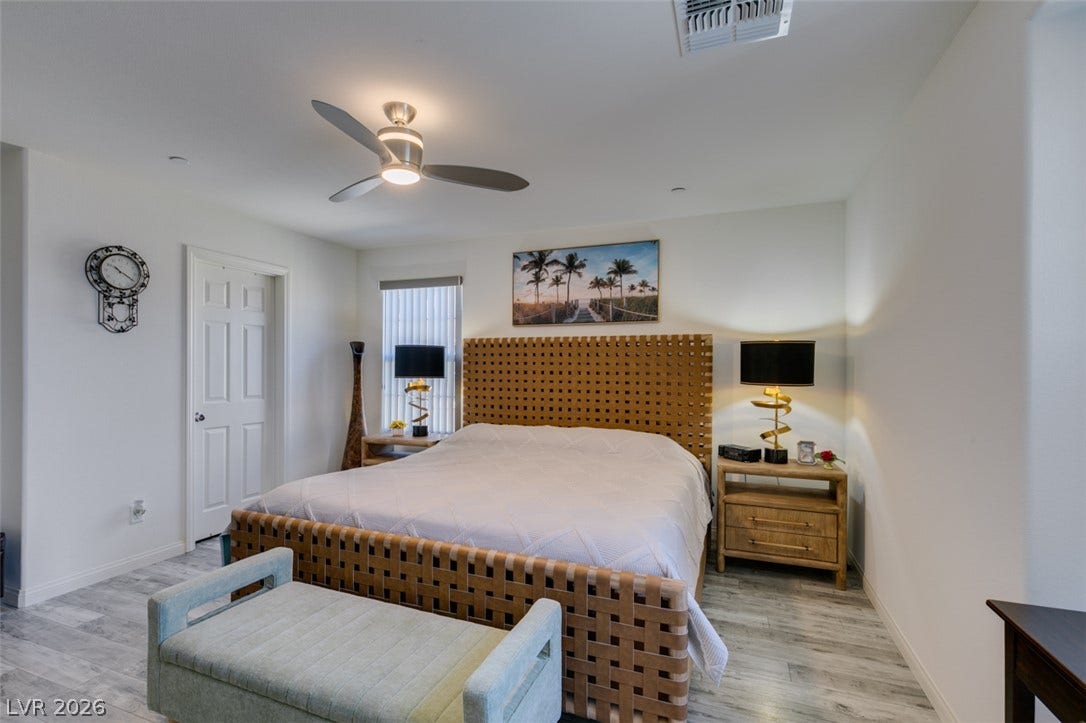 3231 Pergusa Drive, Henderson, NV 89044 Smooth plaster walls and light-toned wood flooring define this serene master suite.