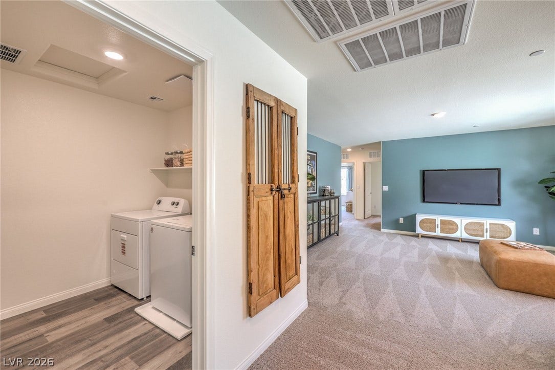 1036 PEACOCK PLUME Street, Henderson, NV 89011 Photo is representational only; actual home finishes may vary. Laundry area featuring attic access, baseboards, washer and dryer, and carpet floors