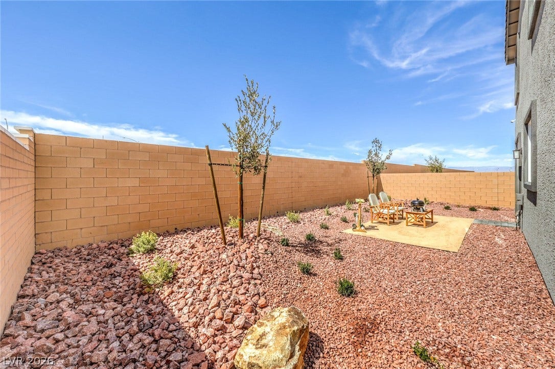 1036 PEACOCK PLUME Street, Henderson, NV 89011 Photo is representational only; actual home finishes may vary. Fenced backyard with a patio area