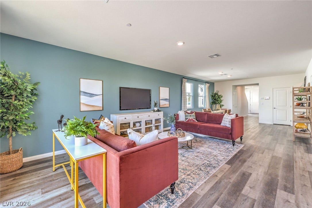 1036 PEACOCK PLUME Street, Henderson, NV 89011 Living area featuring baseboards, wood finished floors, and recessed lighting. Photo is representational only; actual home finishes may vary.