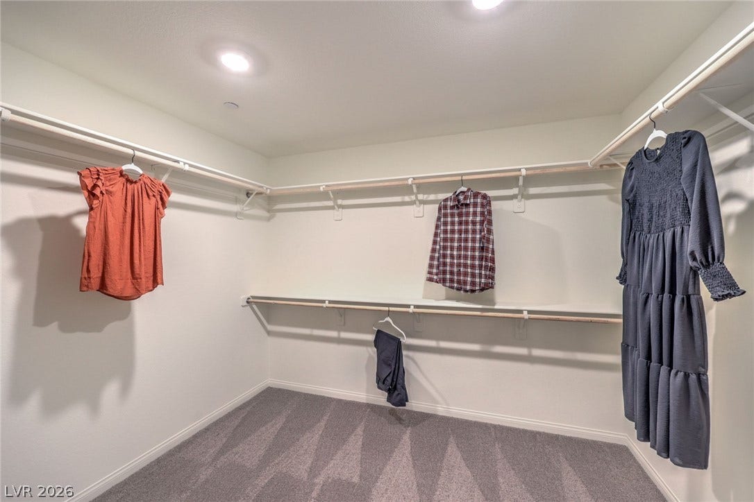 1036 PEACOCK PLUME Street, Henderson, NV 89011 Photo is representational only; actual home finishes may vary. Spacious closet featuring dark colored carpet