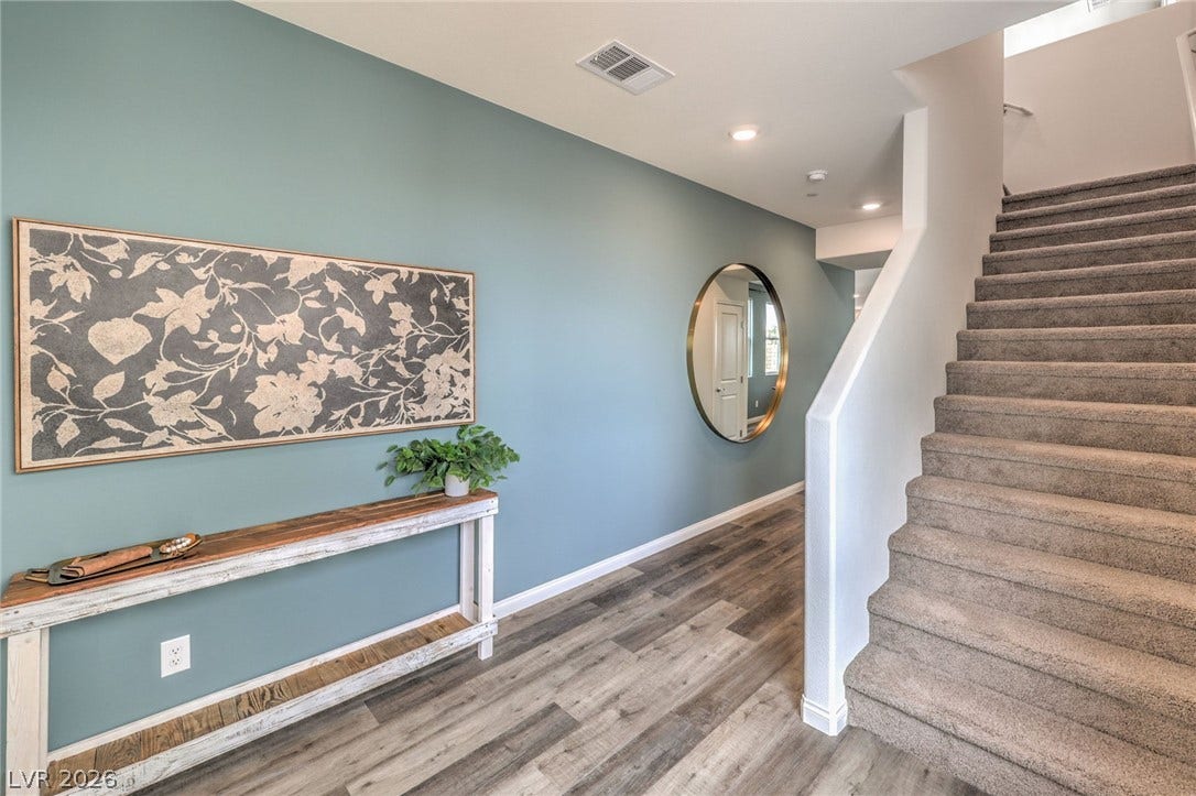 1036 PEACOCK PLUME Street, Henderson, NV 89011 Stairway with wood finished floors, baseboards, and recessed lighting. Photo is representational only; actual home finishes may vary.