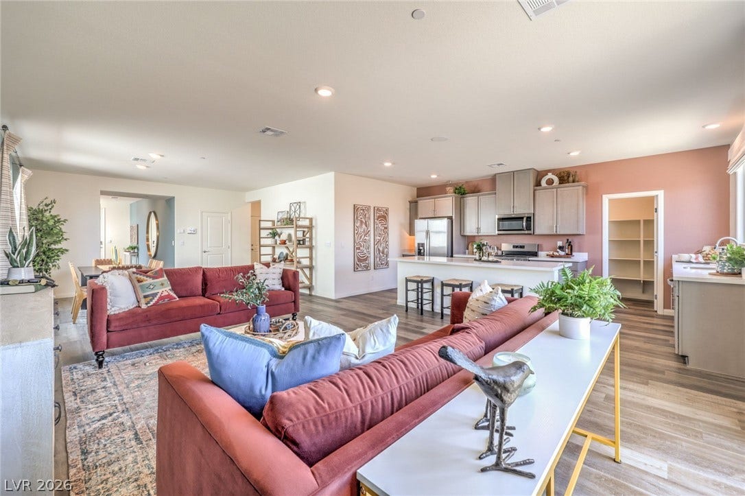1036 PEACOCK PLUME Street, Henderson, NV 89011 Living room with light wood-style flooring and recessed lighting. Photo is representational only; actual home finishes may vary.