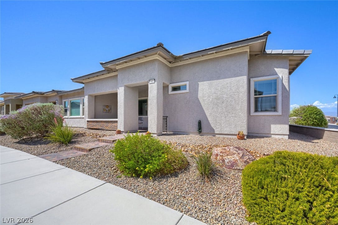 747 Orange Plume Walk, Henderson, NV 89011 Classic stucco exterior and neat desert landscaping create exceptional curb appeal under a clear blue sky.