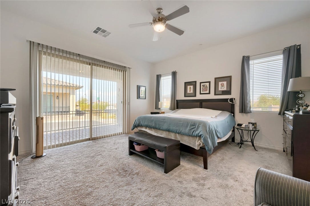 747 Orange Plume Walk, Henderson, NV 89011 Sliding glass doors open from this bedroom to a private outdoor space.