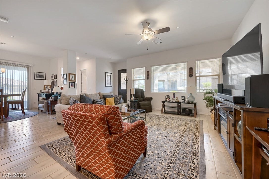 747 Orange Plume Walk, Henderson, NV 89011 An open living space features wood-look tile flooring and windows that welcome natural light.