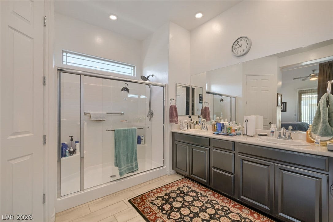 747 Orange Plume Walk, Henderson, NV 89011 A spacious vanity with dual sinks anchors this well-appointed bathroom featuring a glass shower.