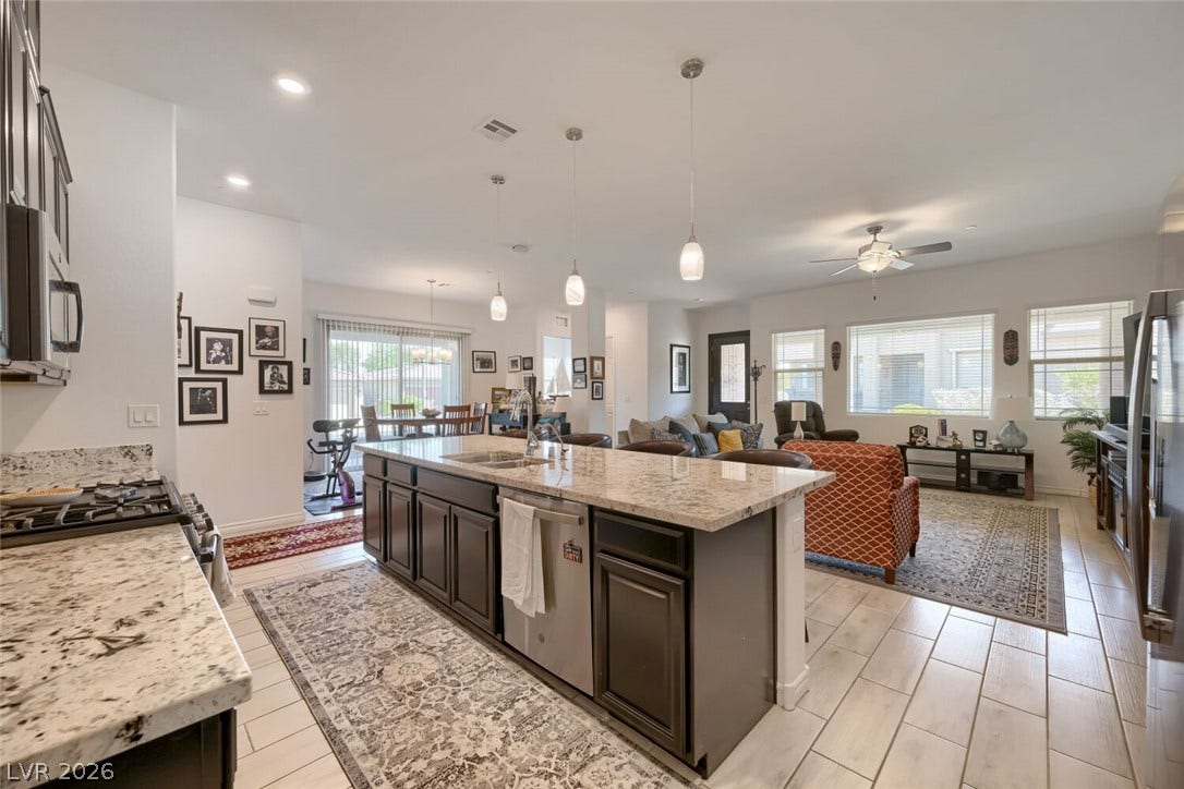 747 Orange Plume Walk, Henderson, NV 89011 An open kitchen layout transitions smoothly into a relaxed living space with tiled flooring.