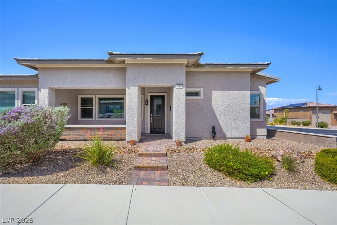 747 Orange Plume Walk, Henderson, NV 89011 A stone-paved walkway leads to the entryway of this modern single-level residence.