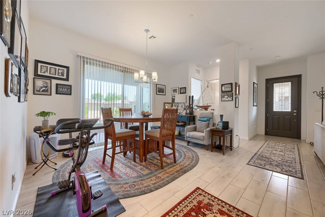 747 Orange Plume Walk, Henderson, NV 89011 Wood-look tile floors and sliding glass doors enhance this open-concept main floor living space.