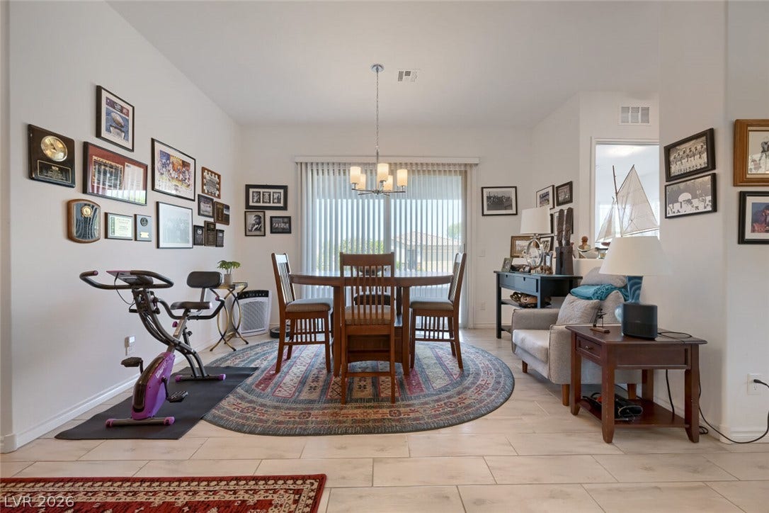 747 Orange Plume Walk, Henderson, NV 89011 Sliding glass doors open from this inviting dining space featuring neutral tile flooring.
