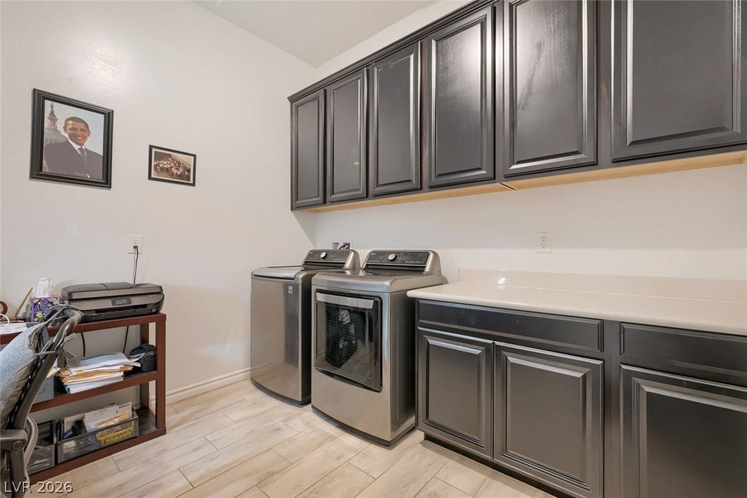 747 Orange Plume Walk, Henderson, NV 89011 A functional workspace joins extensive cabinetry and solid countertops over light wood-look tile floors.