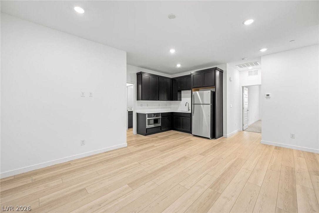 Gleaming light wood flooring extends through a highly versatile open concept living space.