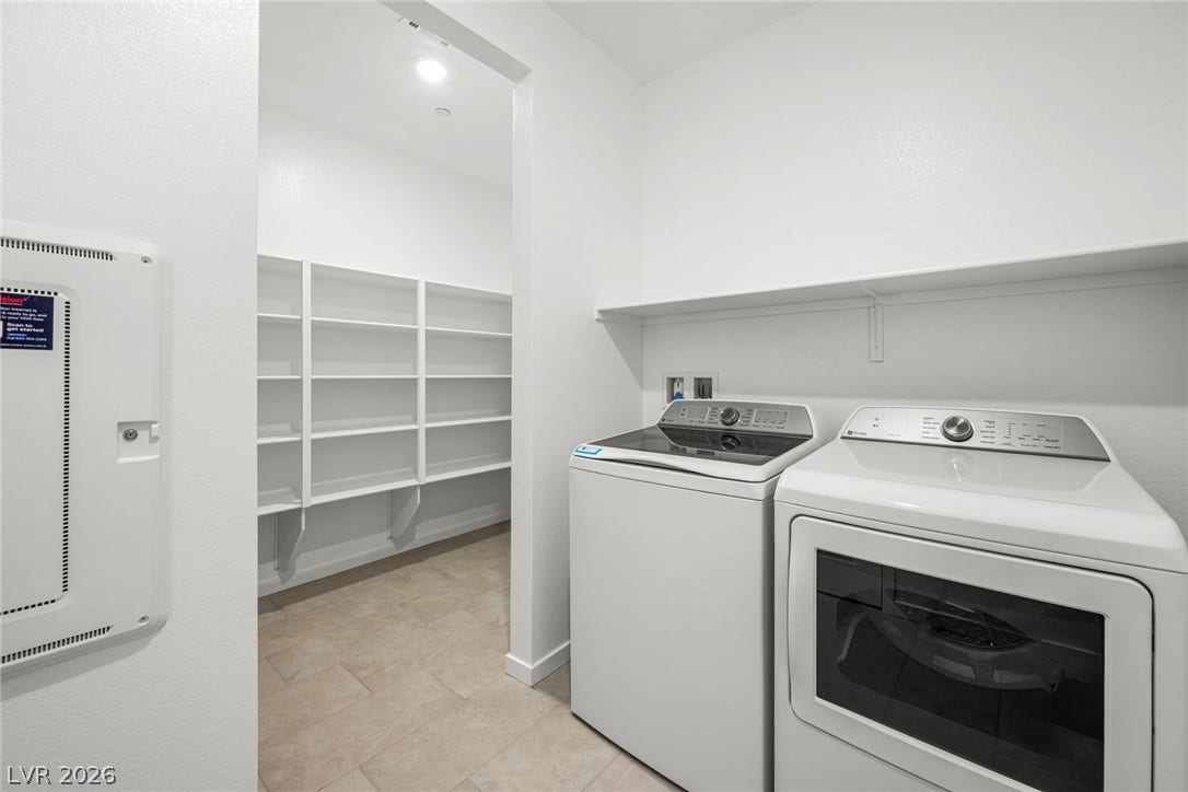 Tiled flooring and open shelving define this functional utility area.