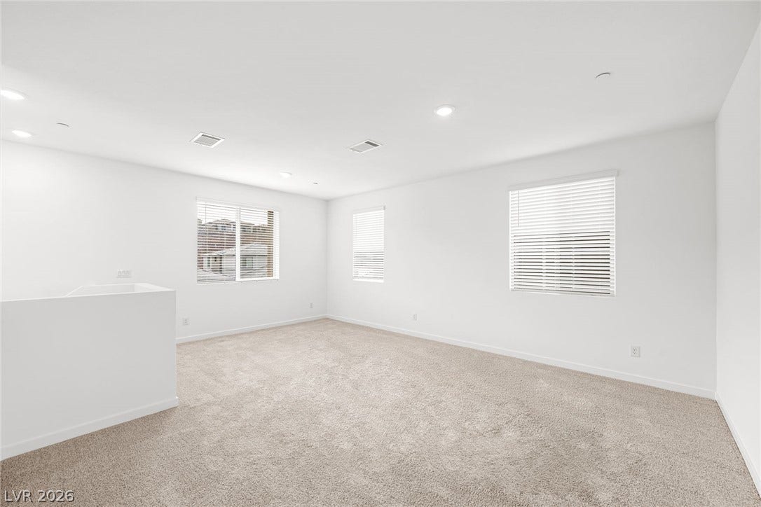 Plentiful natural light streams through multiple windows across this versatile upper level loft space.