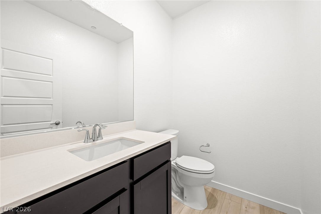 Clean lines and a minimalist vanity define this modern powder room.