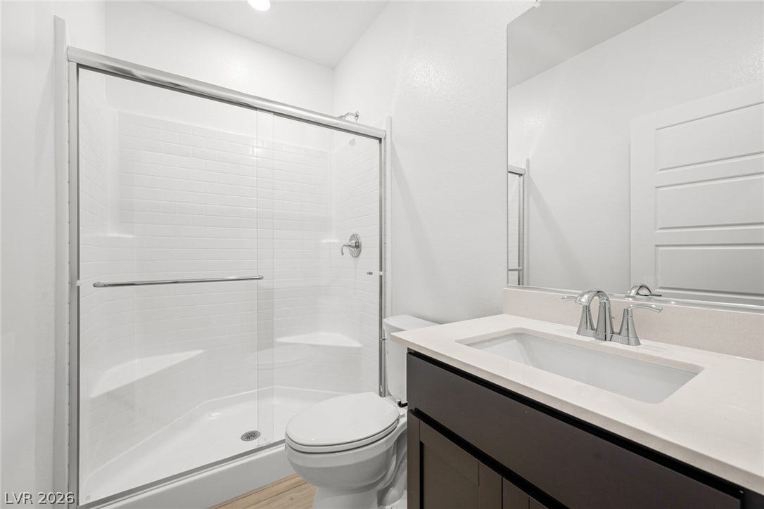 Clean lines and a glass-enclosed shower define this streamlined bathroom space.