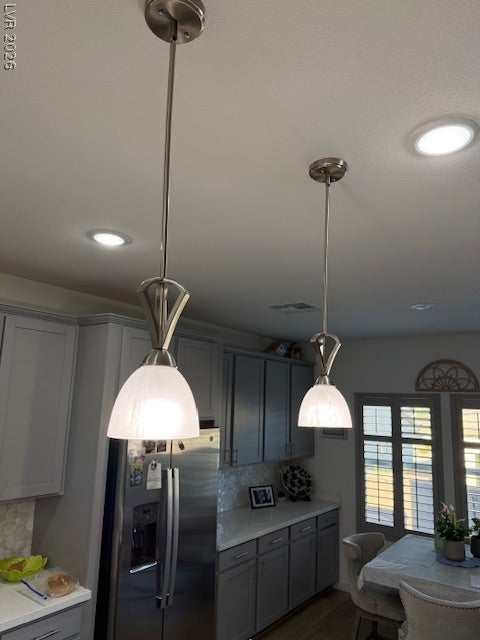 384 Aravalli Crest Street, Henderson, NV 89015 Custom cabinetry and modern pendant lighting illuminate this bright, well-appointed kitchen space.